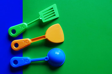Kitchen and cooking utensil toys on blue green background with copy space.  Educational toys for children.