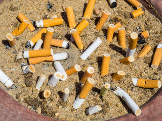 Smoked Cigarettes in the sand ashtray, Stop smoking Concept