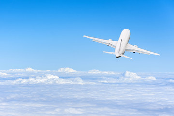 Naklejka na ściany i meble Airplane flies high in the sky on a sunny day, Vacation travel concept.