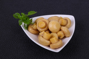 Pickled champignon heap in the bowl