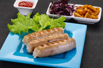 Grilled sausages served mushrooms and cabbage