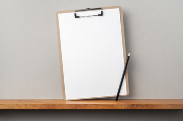 front view of A4 paper with clipboard on bookshelf