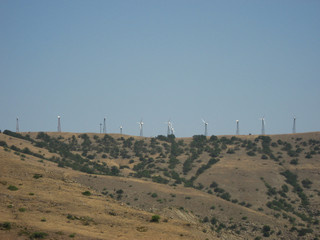 Wind generators are far away on the mountain.