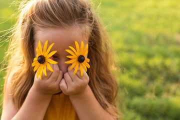 Child with floral eyes enjoying in nature