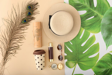 Female accessories with travel objects on color background