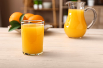 Glass of freshly squeezed orange juice on table