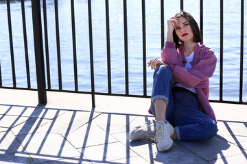 Fashionable young woman on bridge