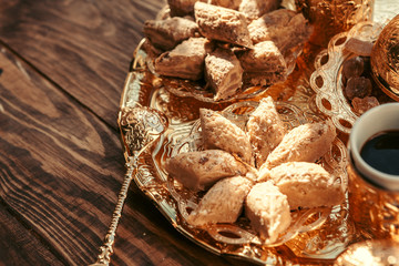 Turkish sweets with coffee on a wooden table