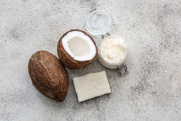 Obraz na płótnie Canvas Jar of coconut oil and soap on light background