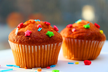 Easter muffins with condensed milk in sweet curly multi-colored topping.