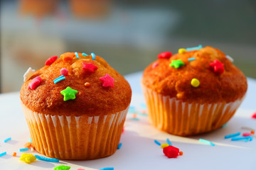 Easter muffins with condensed milk in sweet curly multi-colored topping.