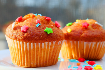 Easter muffins with condensed milk in sweet curly multi-colored topping.
