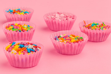 Sugar sprinkles  food background on pink cardboard