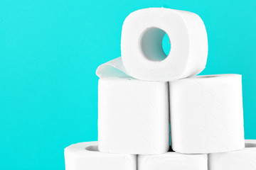 Toilet paper rolls on turquoise bright background