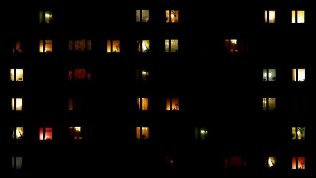 light flickers in the windows of a multistory building. Timelapse. Earth Hour environmental action.