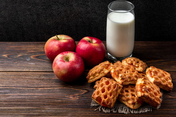 Puff pastry with apple on dark wooden background.