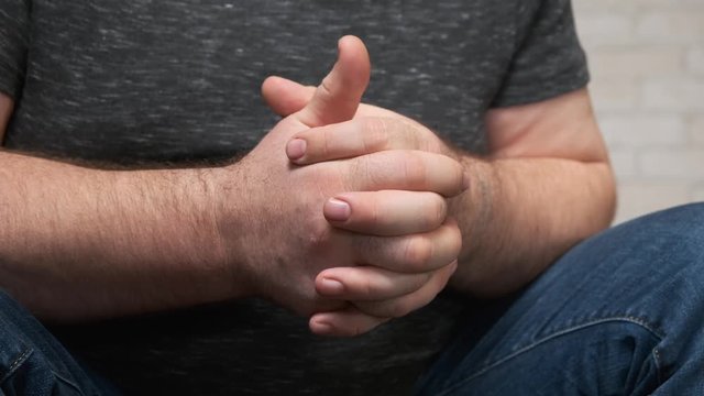 Closeup movement of the hands of a depressed person when talking to a doctor.