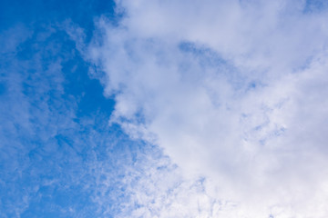 Blue sky in sunny day with white puffy clouds. Natural background