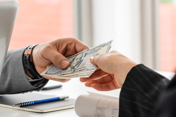 Businessman hand sending money to another business person. Transaction, payment, salary and banking...
