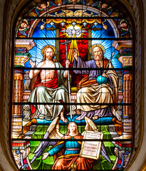 Colorful stained glass showing Chris, Saint Peter and an angel