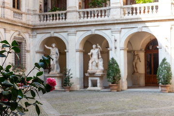 Fototapeta na wymiar Classical statues in an old building courtyard in Rome