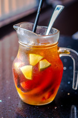 Tropical Fruit Pitcher with tea and kiwi,  orange slices,  strawberries, even lychee