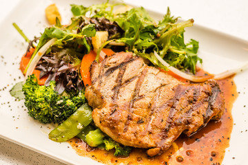 Pork Neck Fillet Steak Very tender and juicy pork collar steak served with garden veggies.  Choice of mushroom/ black pepper sauce.