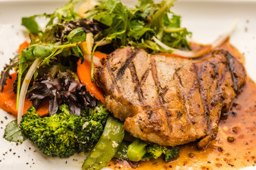 Pork Neck Fillet Steak Very tender and juicy pork collar steak served with garden veggies.  Choice of mushroom/ black pepper sauce.