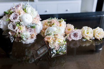 bridal bouquet and bridesmaids with boutonniere on the table