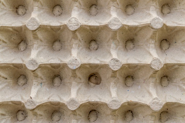 Top view surface sheet of empty cardboard egg crate or eggs carton box made of foam type brown color packing sheet. Old vintage look. Close up. Natural canvas. Studio shot copy space room for text.
