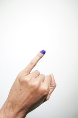 Inked blue finger of a man hand isolated on white background. blue ink blots from voters finger presidential election (pilpres) of indonesia.