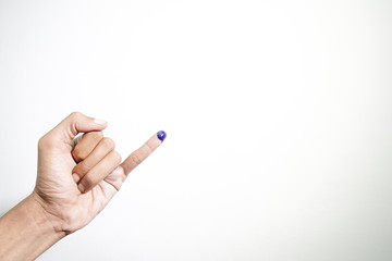 Inked blue finger of a man hand isolated on white background. blue ink blots from voters finger presidential election (pilpres) of indonesia.