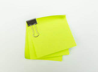 Note with a paper clip. Isolated on a white background with a shadow