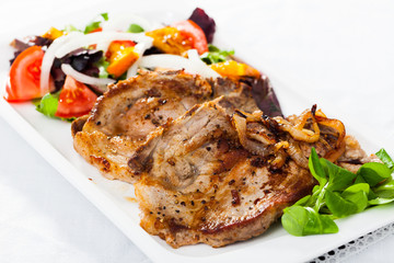 Grilled pork chop with salad