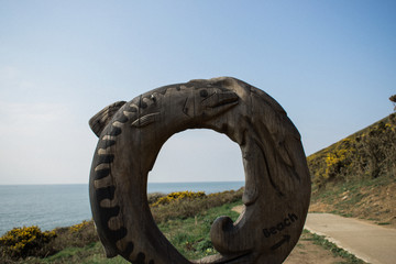 Fototapeta na wymiar Wooden carving next to coastal path