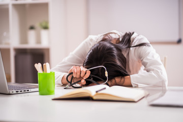 Young doctor is tired from working overtime.