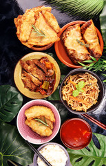 Assorted Chinese food set. Chinese noodles, fried rice, peking duck, dim sum, spring rolls. Famous Chinese cuisine dishes on table. Chinese restaurant