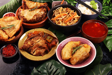 Assorted Chinese food set. Chinese noodles, fried rice, peking duck, dim sum, spring rolls. Famous Chinese cuisine dishes on table. Chinese restaurant