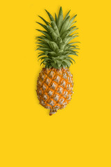 Ripe pineapple at the yellow background. Healthy dietary food.