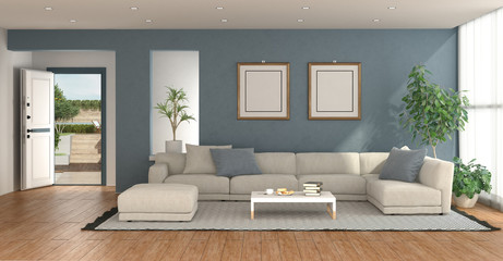 Blue living room with open entrance door