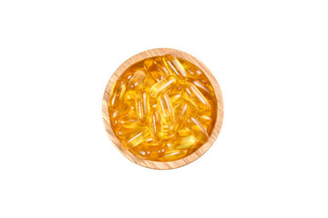 Top view of fish oil capsules in wood bowl isolated on white background. Supplementary food. Omega 3. Vitamin E. Flat lay creative idea.