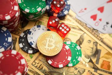 Colorful casino chips, dollars, bitcoins and red dice