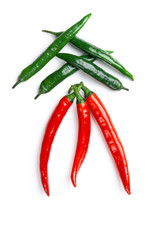 Green and red chili peppers on white background top view. Hot spicy food.