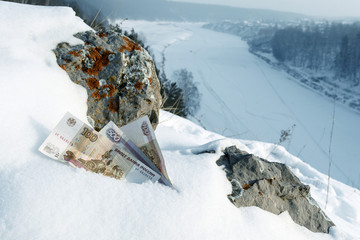 Russian money the rocks and the snow on the top of the mountain background winter river covered