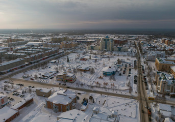 Yugorsk city. Office building of "Gazprom Transgaz Yugorsk" company. Aerial. Winter, snow, cloudy. Khanty Mansiysk Autonomous Okrug (HMAO), Russia.