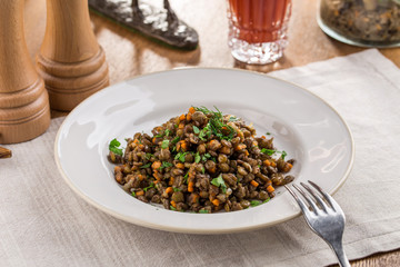 Lentil Salad with Onions, Parsley and carrot and tomato juice on wooden table