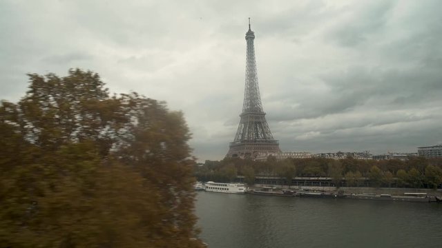 Train crossing La Seine over bridge with Eiffel Tower in the background, Paris, France, view from the train window