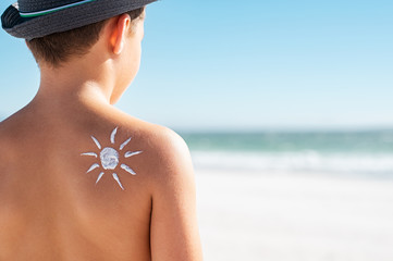 Sunscreen on boy shoulder
