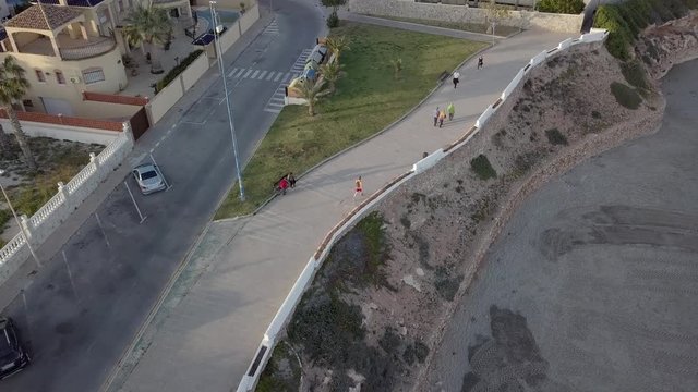 Man running/walking on pavement/promenade in cala cerrada la zenia, Spain.