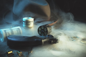 Guns and money.Gangster coat,bullet,dollars .The concept of crime.Smoky background.Retro and vintage style.